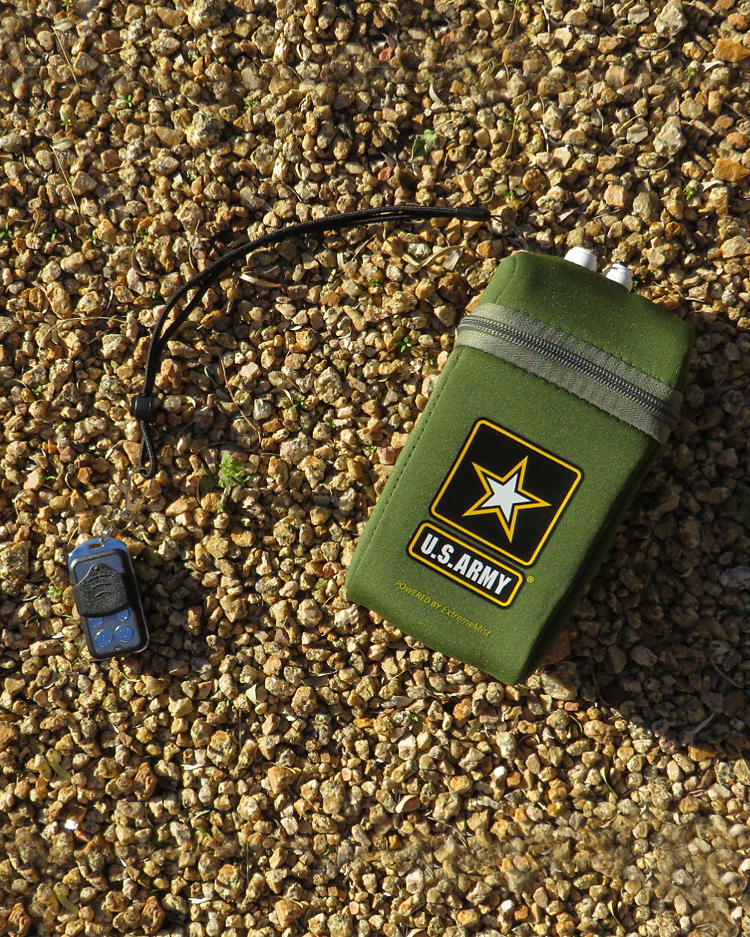 army kit portable misting system pump cover with wireless remote on gravel