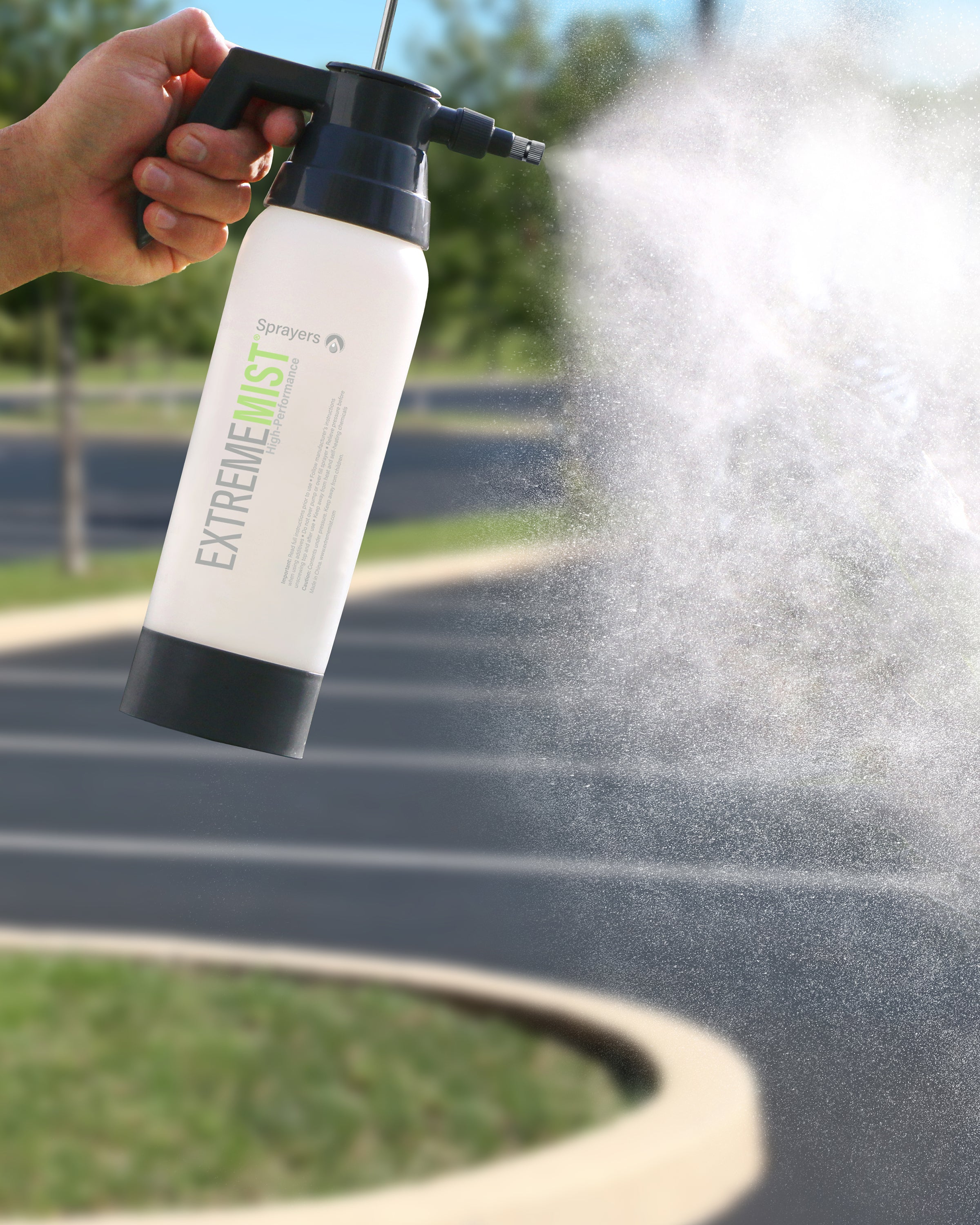 car mister pump-up sprayer spraying mist in parking lot
