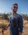 hiker in desert wearing misting hydration backpack