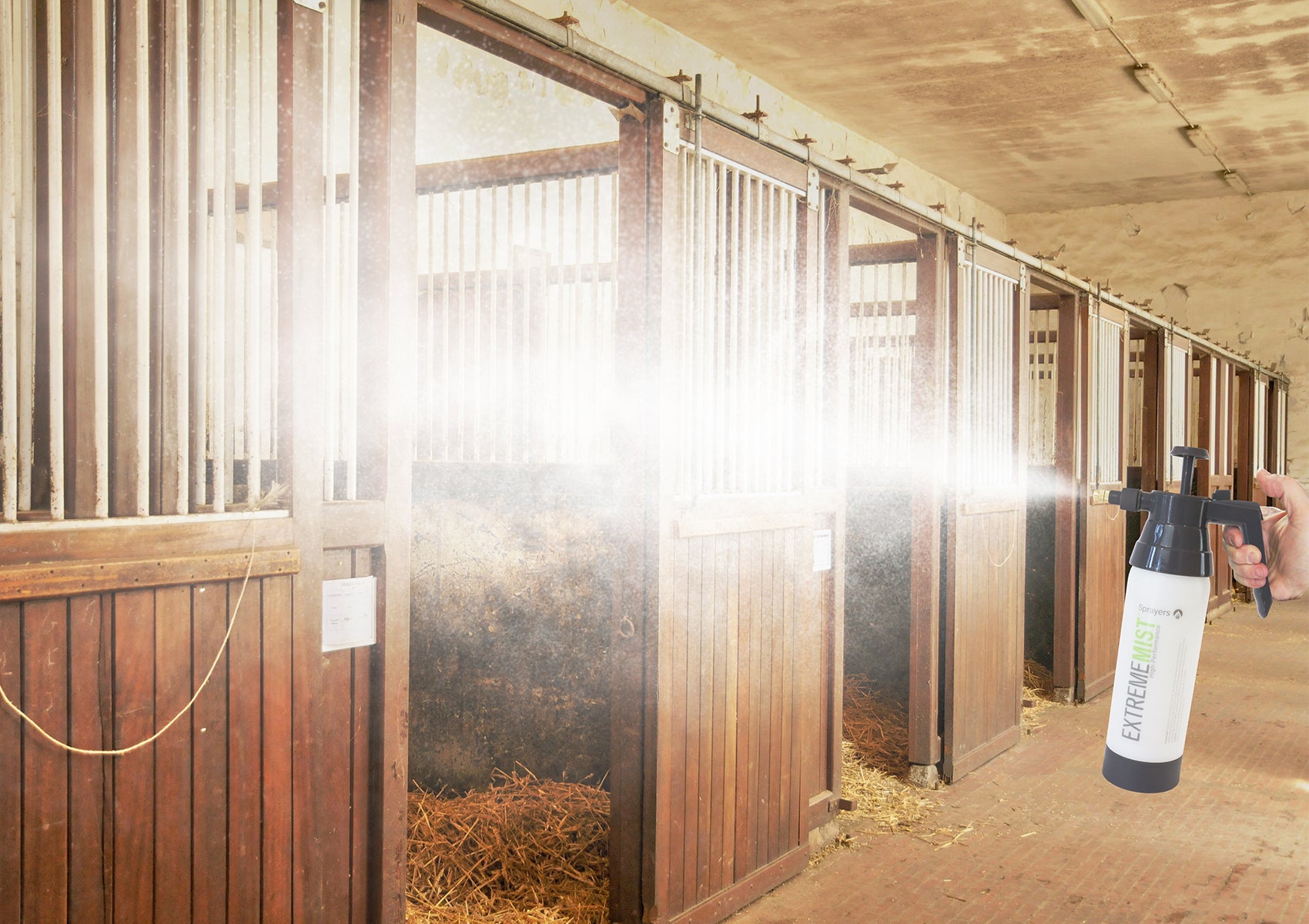 horse mister pump-up sprayer misting a horse stable
