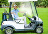 golfer in golf cart cooling down with misting water bottle