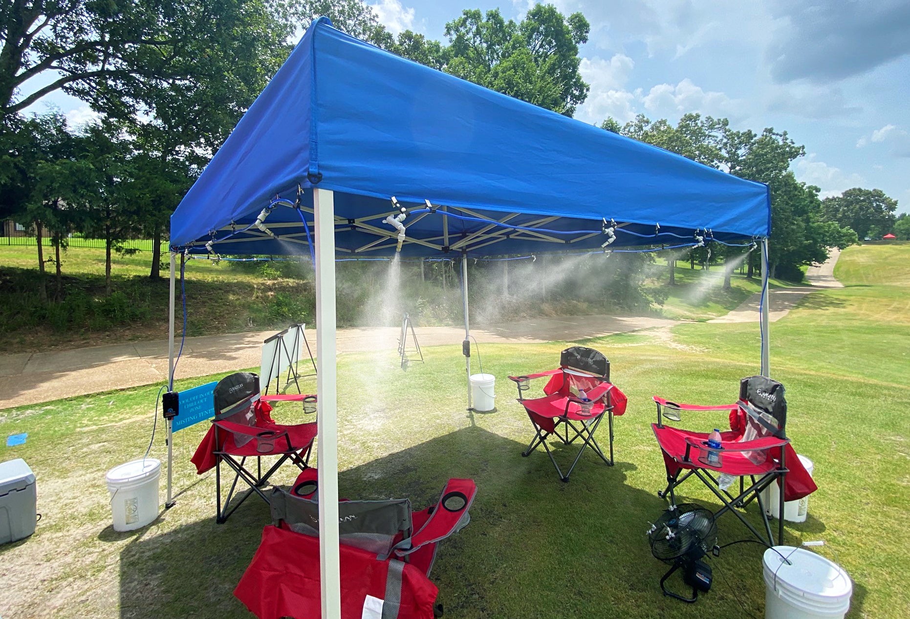 portable misting system attached to canopy on golf course