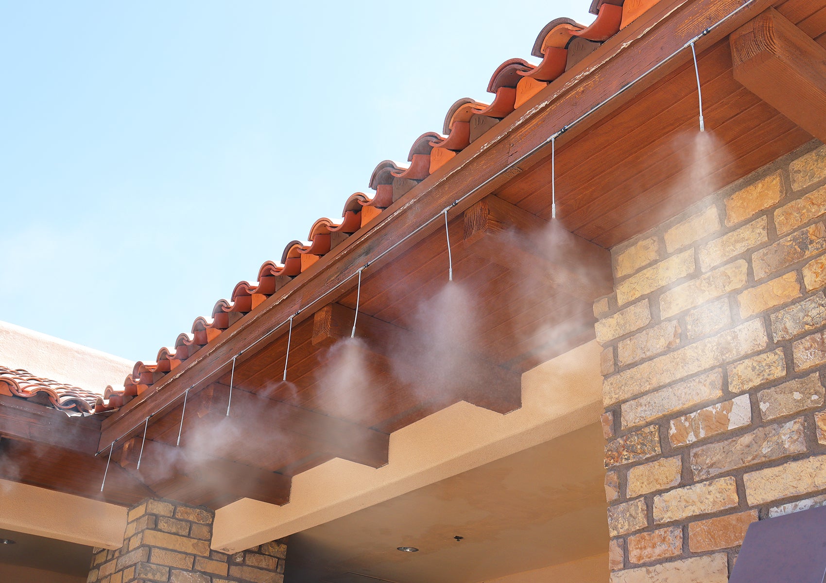 high pressure misting system with extended nozzle pipes cooling outdoors