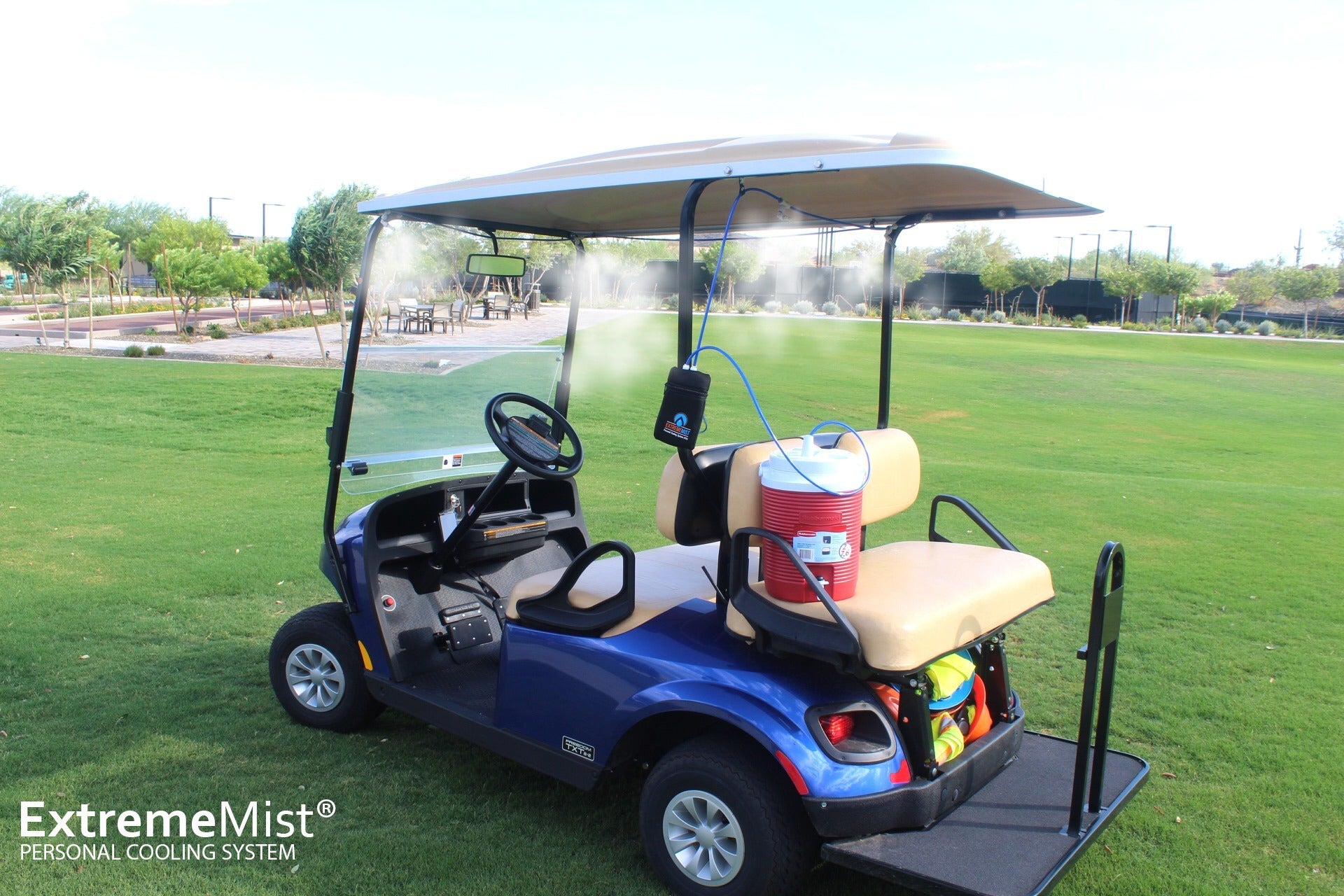 portable misting system attached to golf cart with water cooler supplying water