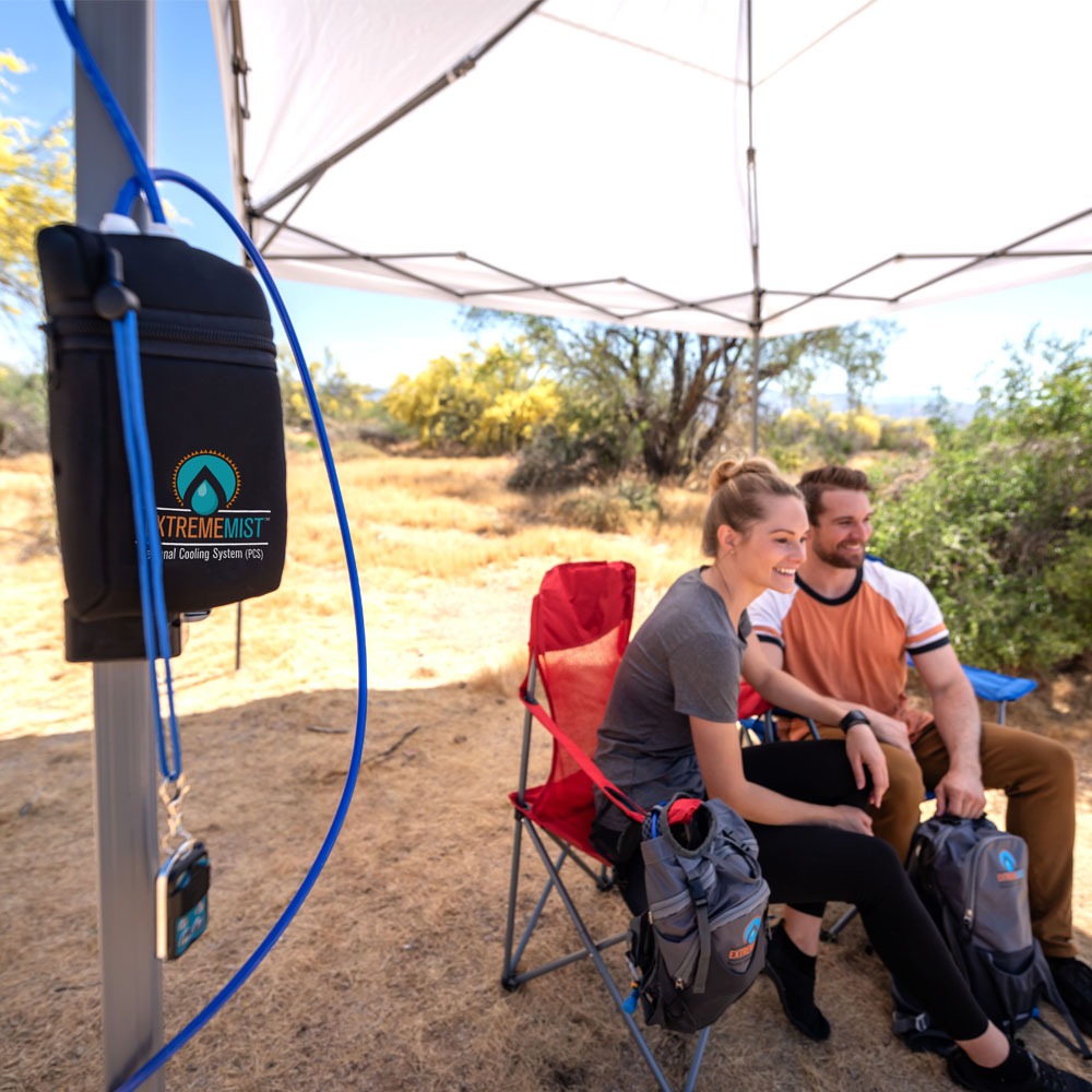 pump strapped to canopy with campers being cooled by portable misting system