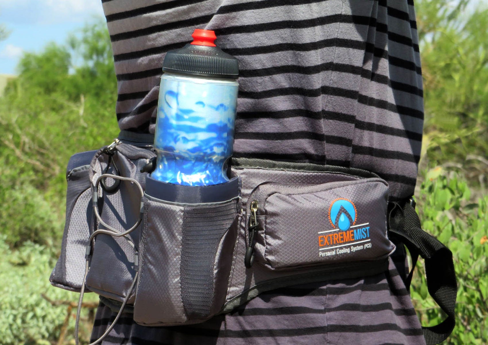 hiker wearing gray waist pack with athletic bottle inside holster